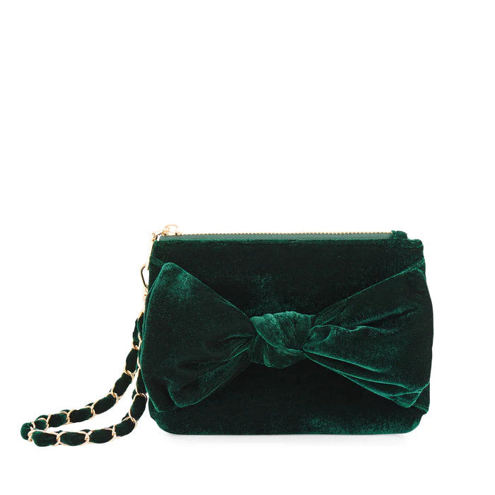 Emerald green velvet evening handbag displayed on a white background featuring a large decorative bow and a gold-tone chain strap interwoven with matching fabric ribbon