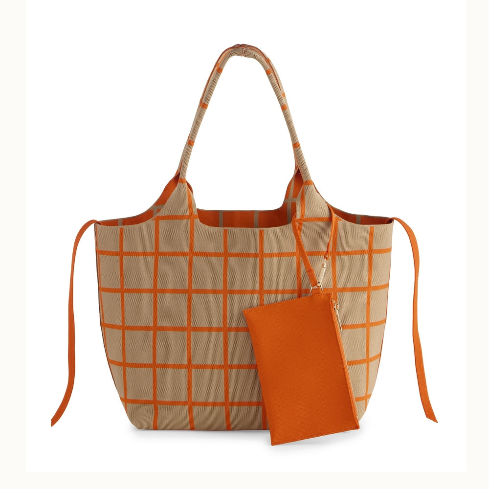 Knitted fabric tote bag featuring a vibrant orange windowpane grid pattern on a beige base with a matching detachable zippered pouch and decorative side ties against a minimalist white background