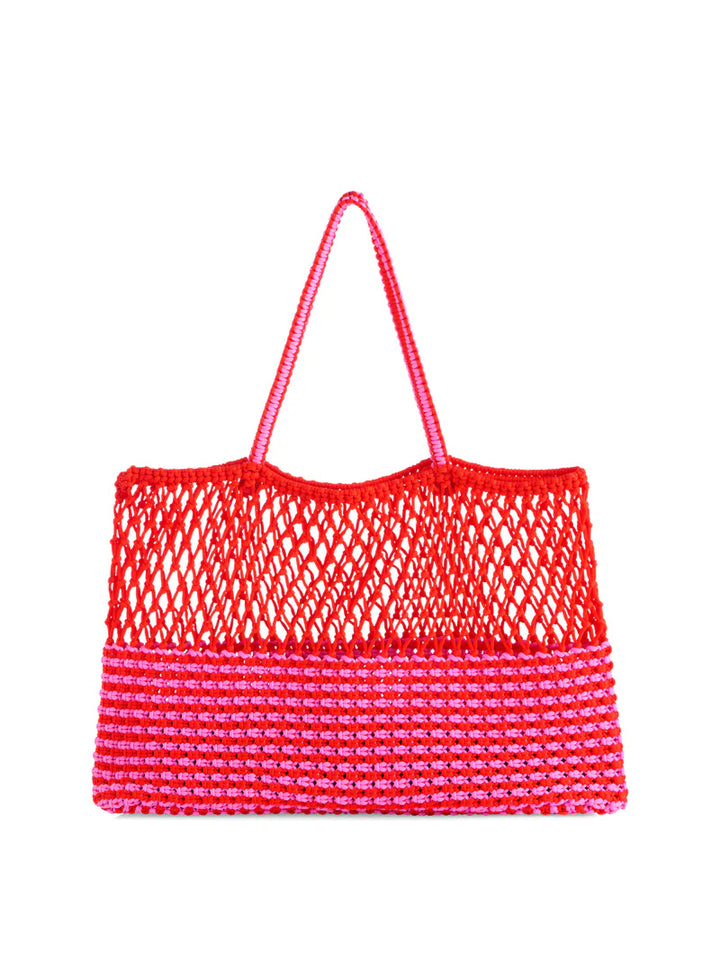 Hand-crocheted cotton tote bag centered on a white studio background featuring a vibrant red open-mesh top and a bold pink and red striped lower panel with thin braided handles