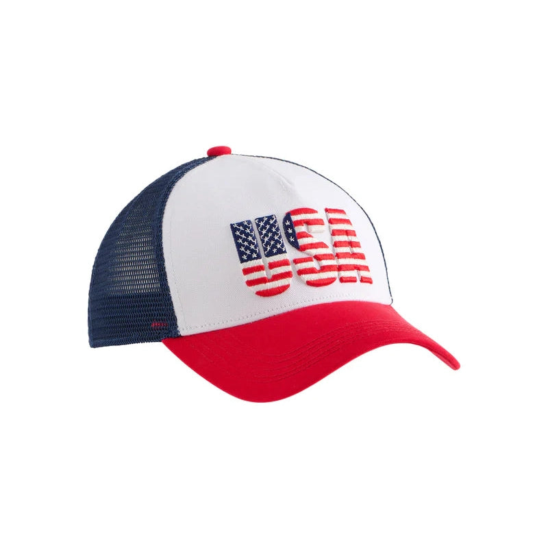 Product photograph of a patriotic mesh-back trucker hat featuring the letters USA embroidered with an American flag motif on a white front panel with a red curved brim and navy blue mesh backing