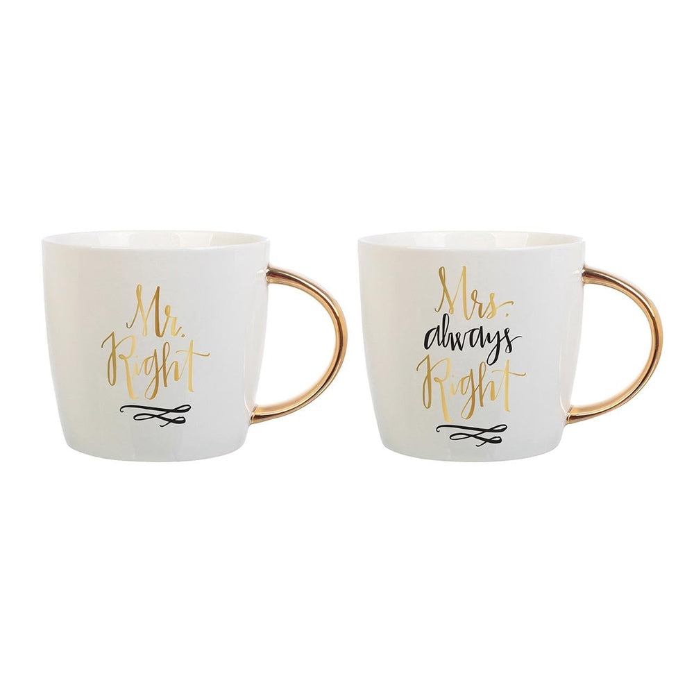 White ceramic mugs featuring a pair of novelty wedding cups on a white background with gold-toned handles, metallic gold calligraphy reading Mr. Right and Mrs. Always Right, and black decorative scroll accents
