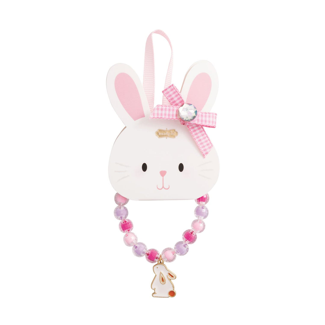 Mud Pie beaded jewelry set featuring a white bunny charm with a red tail, pink and purple translucent beads, and a pink gingham bow with a gemstone centerpiece attached to a white rabbit-shaped display card