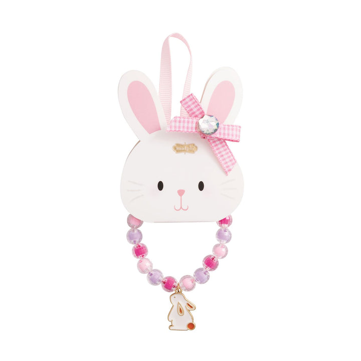Mud Pie beaded jewelry set featuring a white bunny charm with a red tail, pink and purple translucent beads, and a pink gingham bow with a gemstone centerpiece attached to a white rabbit-shaped display card