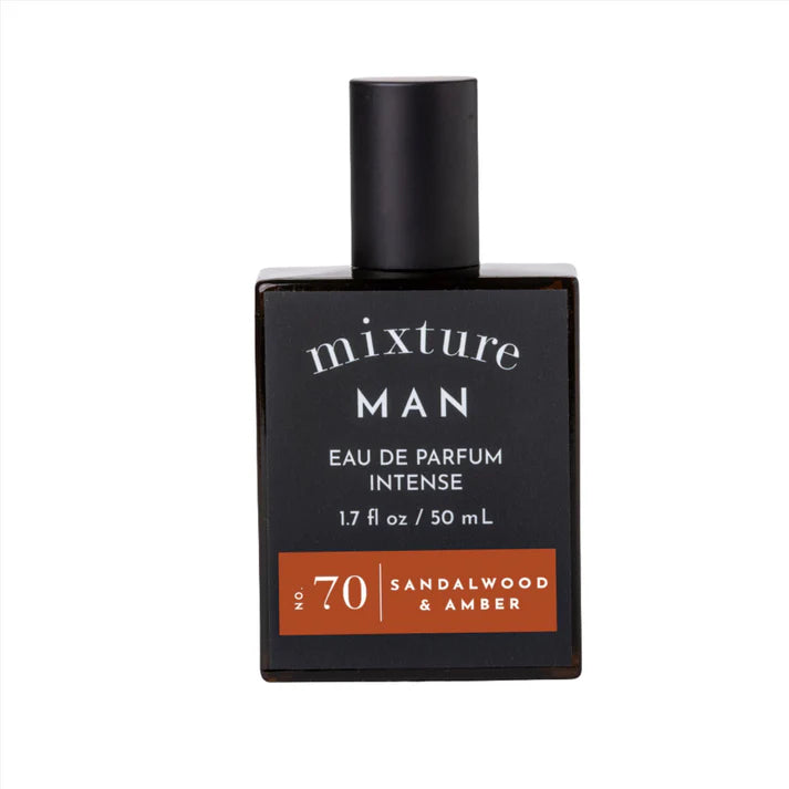 Studio product photograph of a Mixture Man Eau De Parfum Intense bottle on a white background featuring a black cylindrical cap, white serif typography, and a burnt orange accent label for No. 70 Sandalwood and Amber