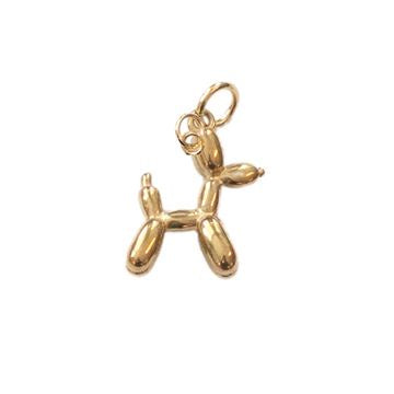 Gold-toned jewelry charm in the style of Jeff Koons featuring a polished balloon dog on a white background with a reflective metallic surface and a small circular bail