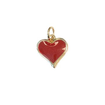 Enamel and gold-plated jewelry charm featuring an iconic heart-shaped design with a speckled crimson finish and a polished gold border including a top jump ring set against a white background