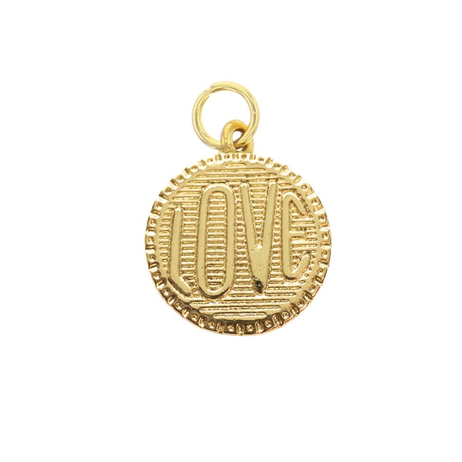 Gold-toned metal charm featuring the word LOVE in iconic vertical block lettering centered on a white background with a textured horizontal ridged interior and a decorative beaded circular border