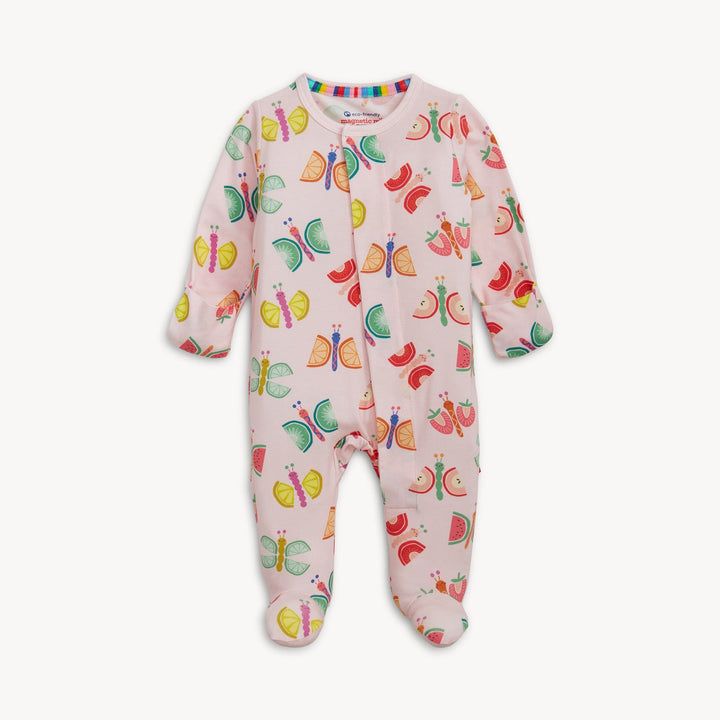 Fabric garment by Magnetic Me showcasing a pink baby footie with a pattern of butterflies with fruit-slice wings and a rainbow-striped collar on a plain white background