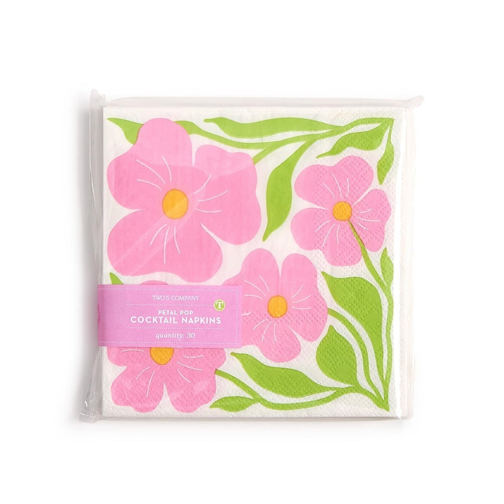 Paper cocktail napkins by Two's Company featuring the Petal Pop floral design centered on a white background with large pink flowers, yellow centers, and vibrant green stems wrapped in a pink paper band