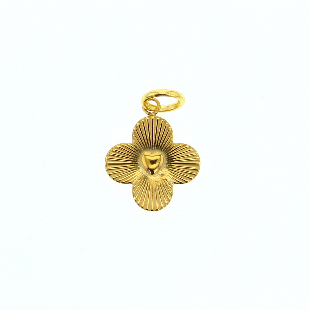 Gold jewelry pendant shaped like a four-petal flower featuring a central heart motif and radiating linear sunburst textures centered on a white background