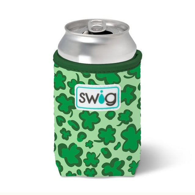 Commercial product photography by Swig Life features a mint green can cooler with a vibrant dark green shamrock pattern holding a silver aluminum beverage can and showcasing a white rubberized logo patch against a clean white background