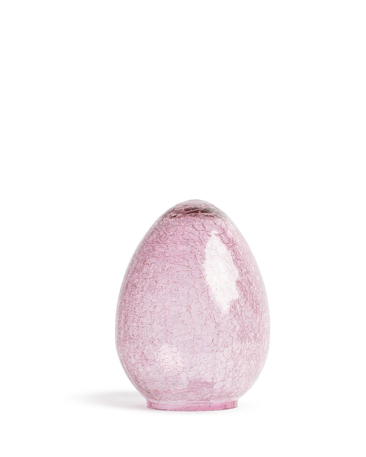 Hand-blown pink crackle glass egg-shaped lamp shade centered in a white studio setting featuring a soft rose-pink hue, intricate web-like textures, and a polished reflective exterior