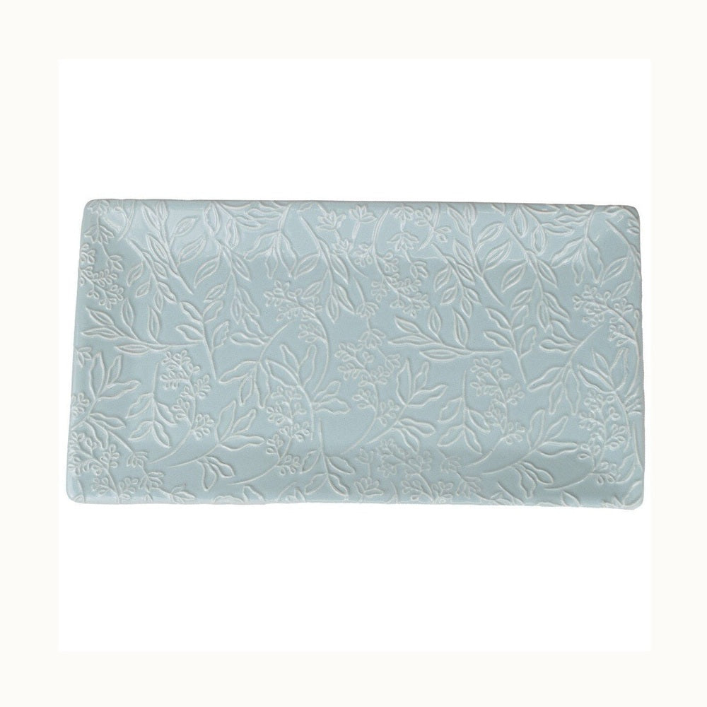 Glazed ceramic rectangular tray featuring an intricate embossed botanical relief of delicate vines and leaves in a soft powder blue finish with white highlights against a white background