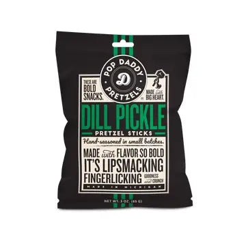Product packaging design by Pop Daddy for Michigan-made Dill Pickle Pretzel Sticks featuring a black bag with bold green typography, a circular company seal, and detailed cream-colored text