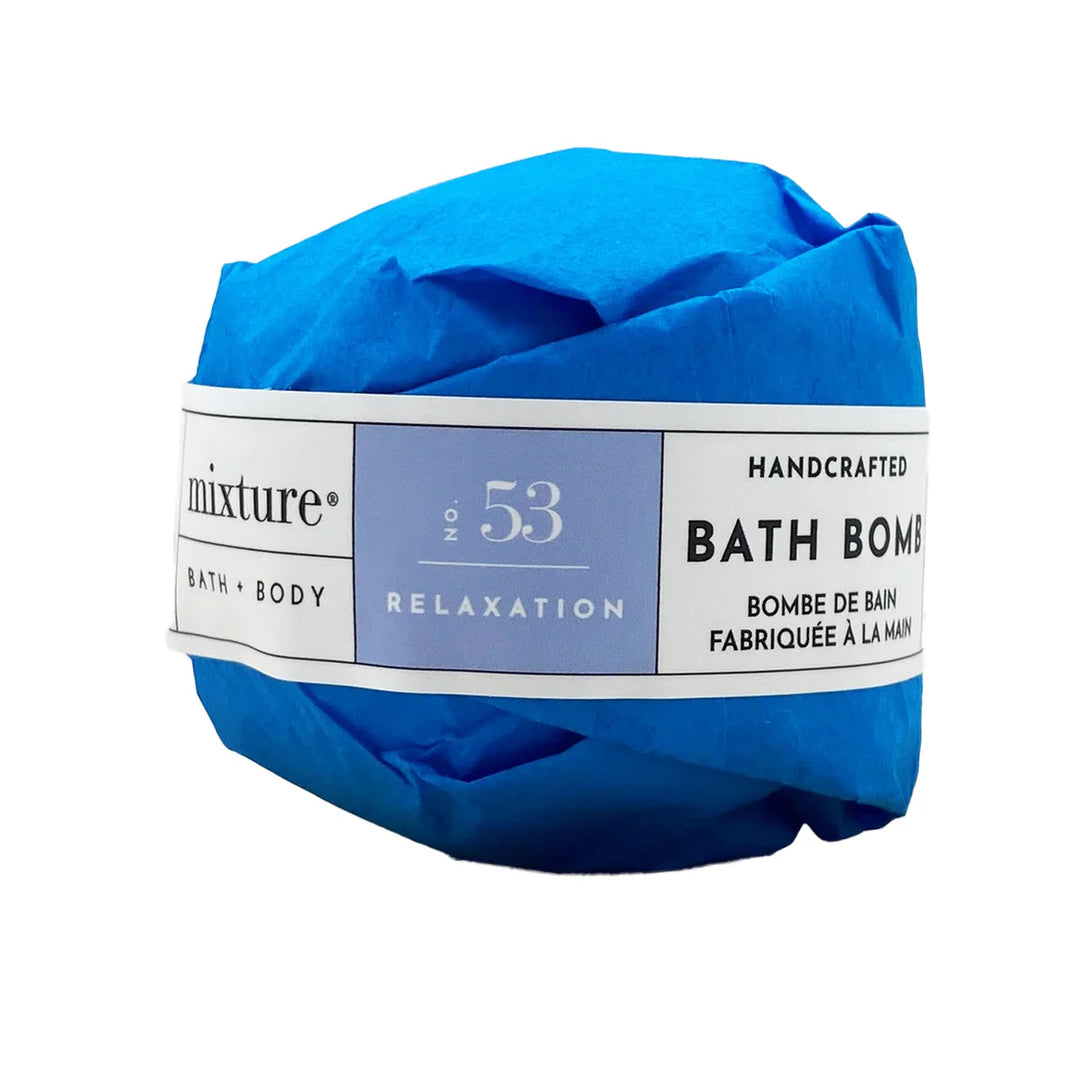 Product photograph by Mixture of a handcrafted No. 53 Relaxation bath bomb wrapped in vibrant cobalt blue tissue paper with a white label featuring minimalist black typography against a clean white background