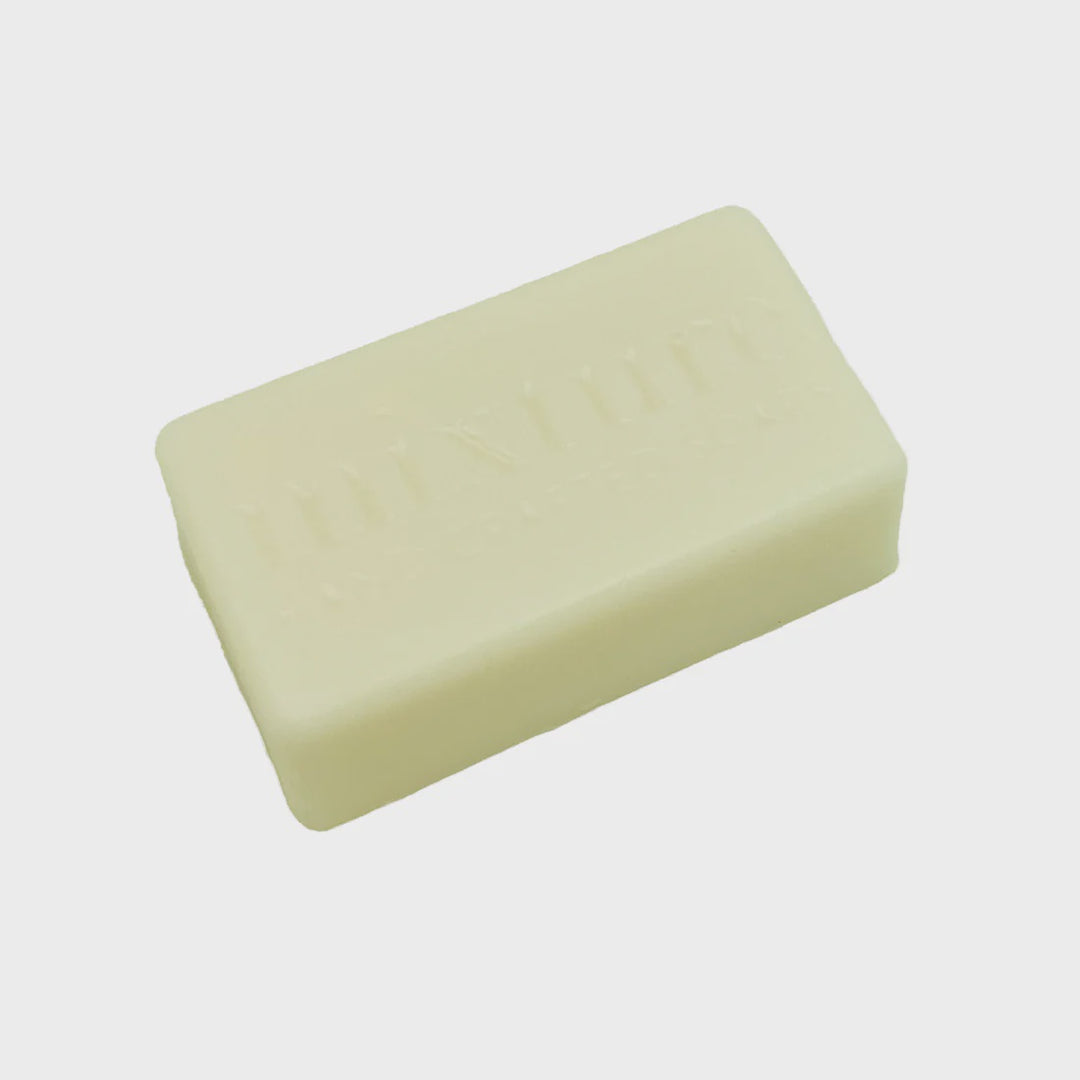 Handcrafted bar soap by Mixture featuring a rectangular cream-colored bar with an embossed brand logo and smooth matte texture against a neutral background