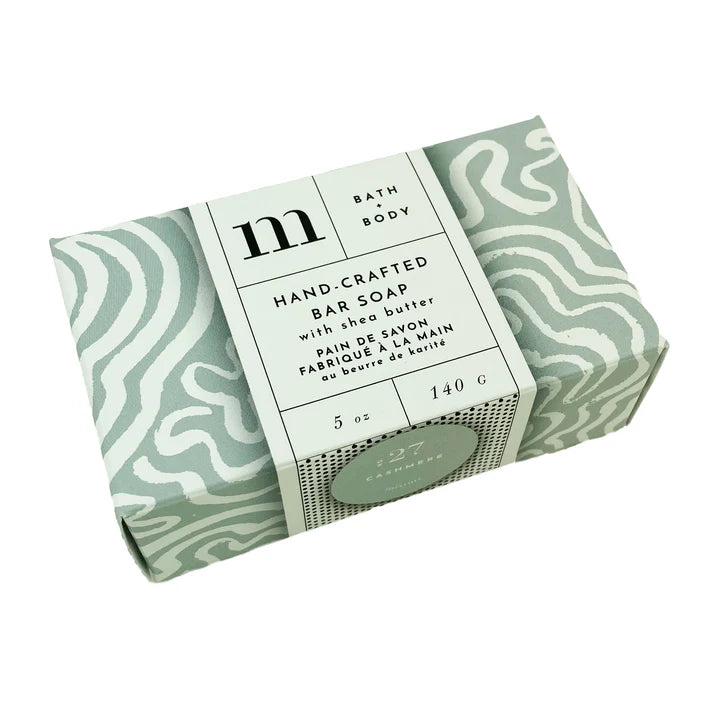 Product photograph of Michaud hand-crafted shea butter bar soap wrapped in a sage green wavy pattern with a central white label featuring black serif typography and a small green No. 27 Cashmere seal on a plain white background