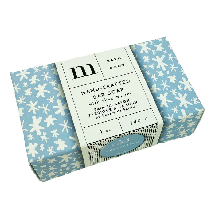 Product photograph of Michaud hand-crafted bar soap on a white background featuring a light blue snowflake-patterned wrapper and a cream-colored paper band with a black m logo and a small blue No 53 relaxation seal