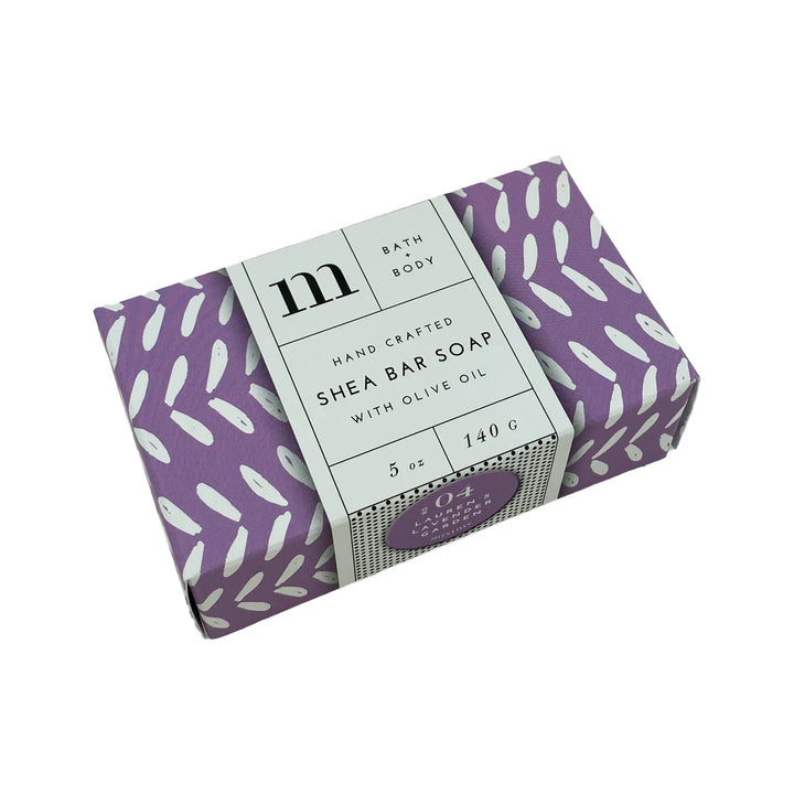 Product photograph of Mixture handcrafted shea bar soap featuring a purple box with white leaf-like patterns and a minimalist white label displaying a large black serif letter m and a small 04 Lavender Garden seal on a plain white background