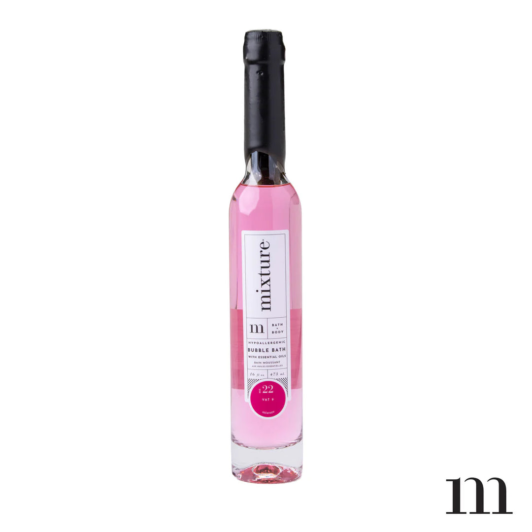 Product photograph by Mixture featuring a tall slender glass bottle of pink bubble bath with a black wax-dipped seal and a white Vat 9 label against a clean white background