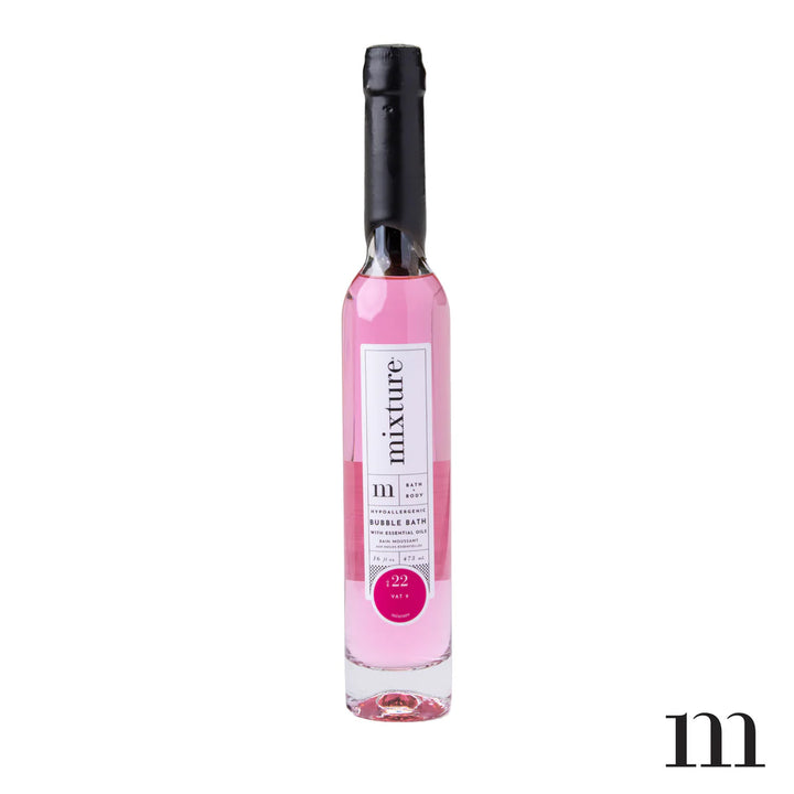Product photograph by Mixture featuring a tall slender glass bottle of pink bubble bath with a black wax-dipped seal and a white Vat 9 label against a clean white background