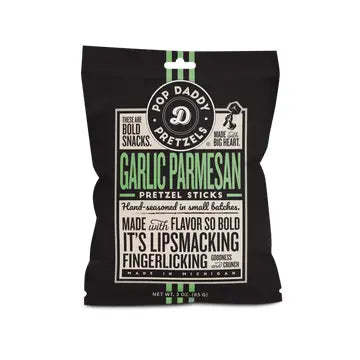 Product photography by Pop Daddy of Garlic Parmesan Pretzel Sticks in a black bag accented with mint green typography, the iconic circular company logo, and vintage-style lettering highlighting its Michigan roots