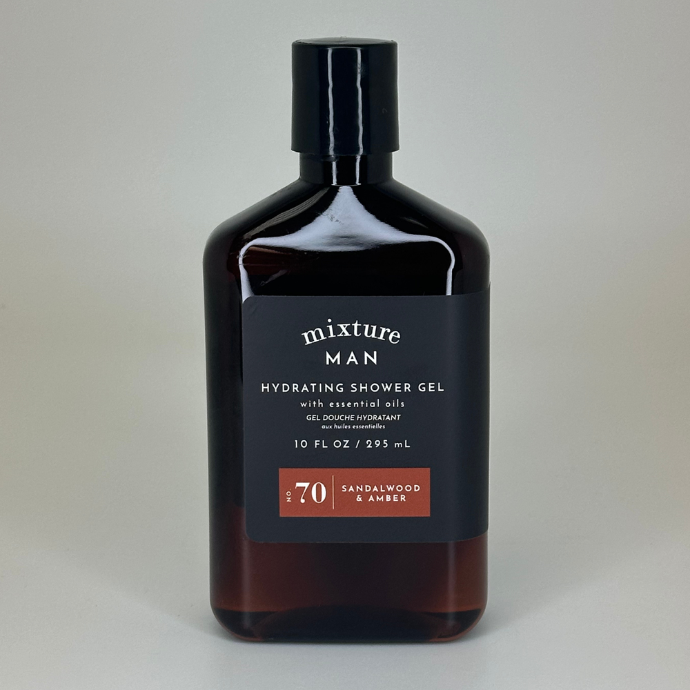 Product photograph by Mixture featuring a bottle of Sandalwood & Amber hydrating shower gel in a neutral studio setting, highlighting the dark amber-tinted container, a matte black label with white typography, and a prominent reddish-brown No 70 graphic element