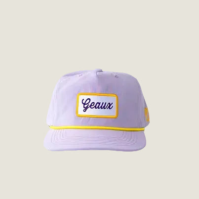 Purple cap with yellow and white text on a light gray background