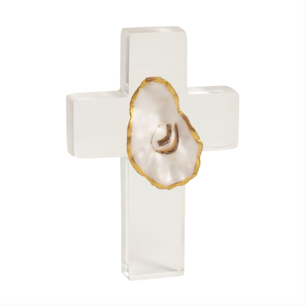 Acrylic sculpture by Grit and Grace Studio of a clear decorative cross on a white background featuring an authentic oyster shell with a hand-painted gold leaf rim and a natural pearlescent finish