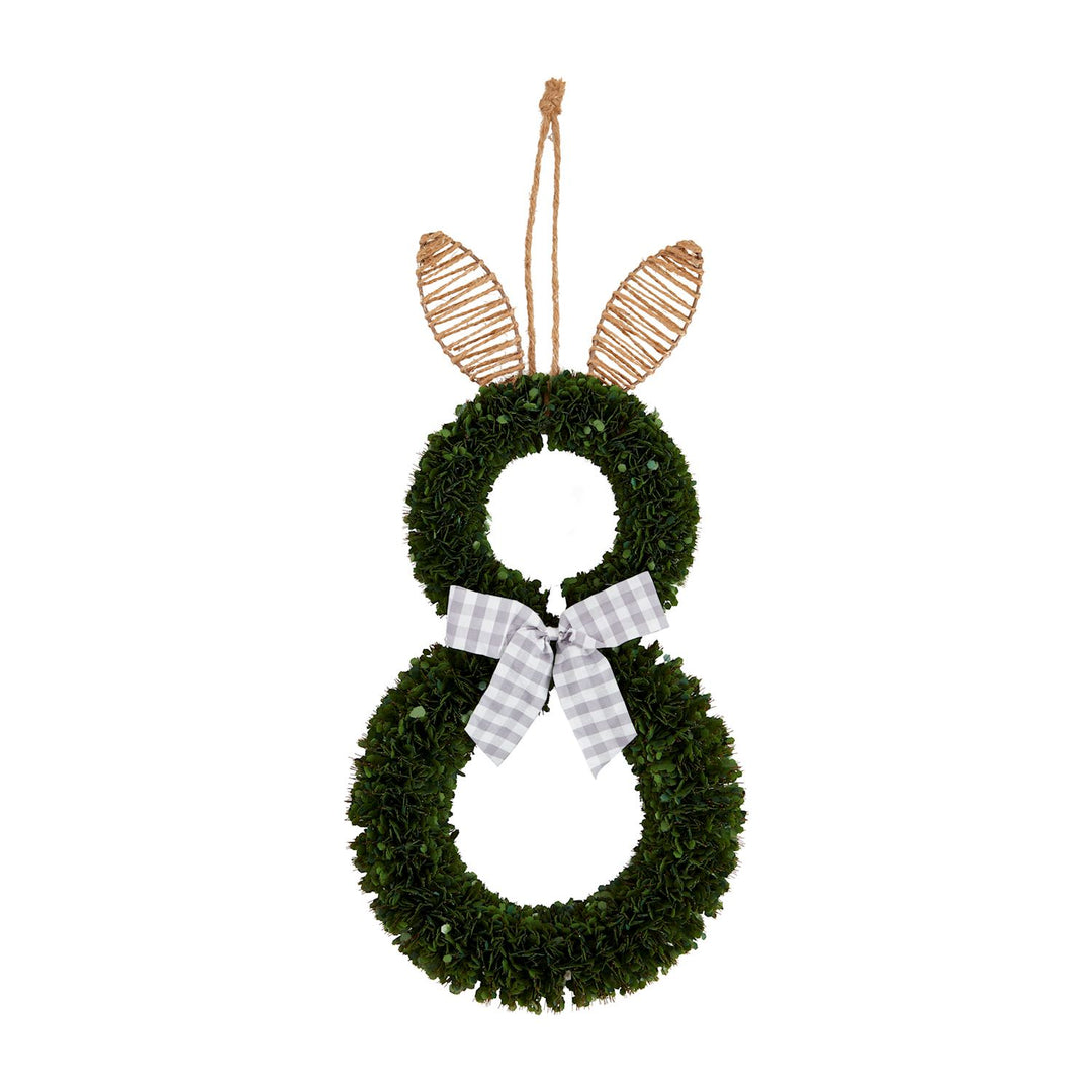 Artificial greenery and jute wreath depicting a bunny silhouette against a white background featuring woven twine ears and a grey and white gingham ribbon bow at its neck