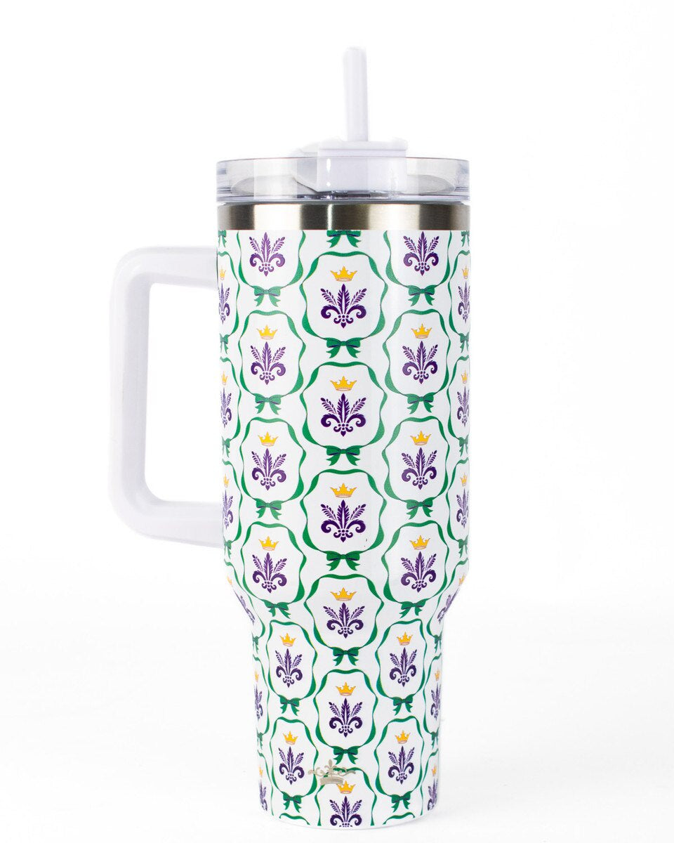 Insulated stainless steel tumbler featuring a New Orleans Mardi Gras theme with a repeating pattern of purple fleurs-de-lis, golden crowns, and green scalloped borders with a white handle and straw