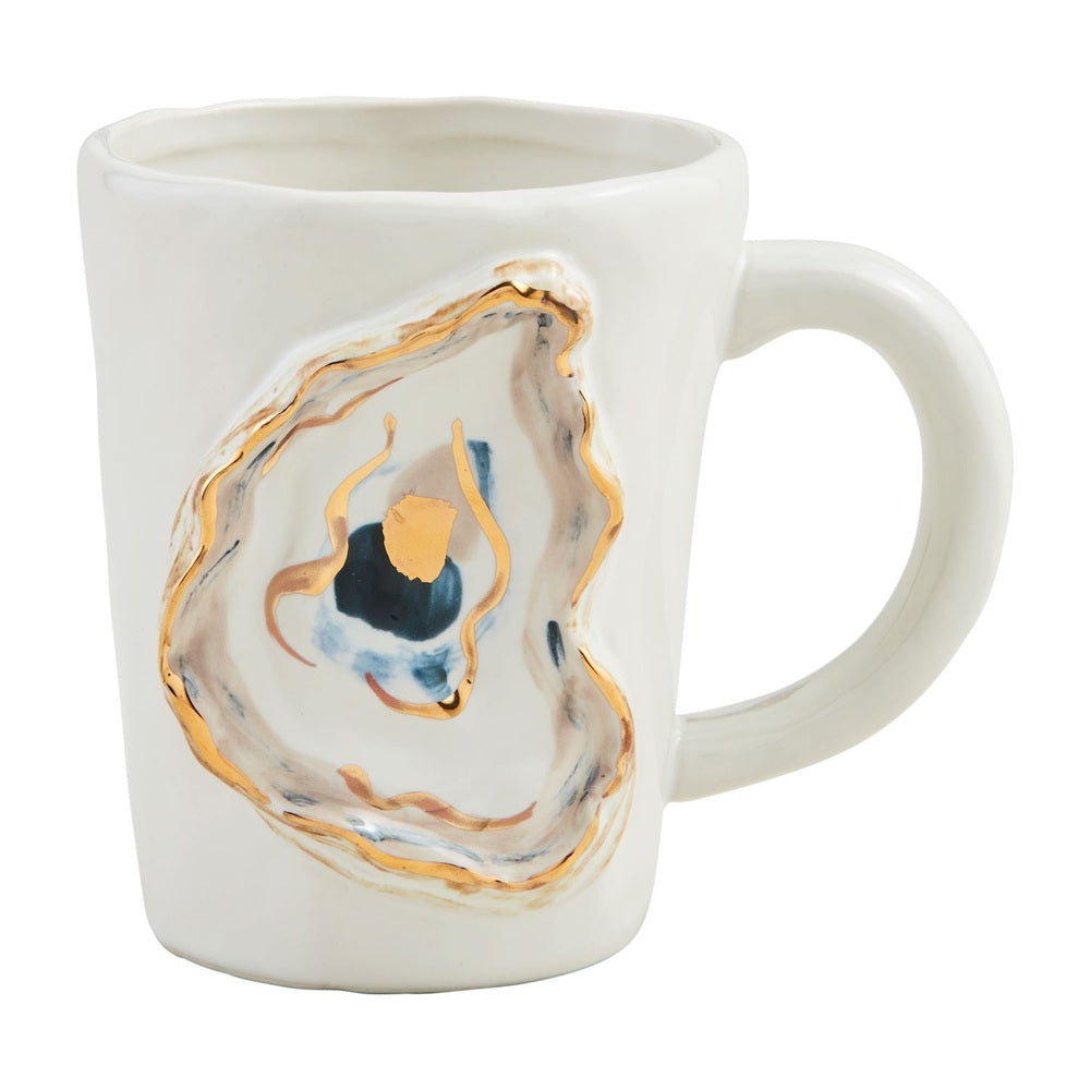 Hand-painted ceramic mug by Mud Pie featuring a sculpted oyster shell motif with gold metallic foil trim and navy blue watercolor accents on a textured white surface