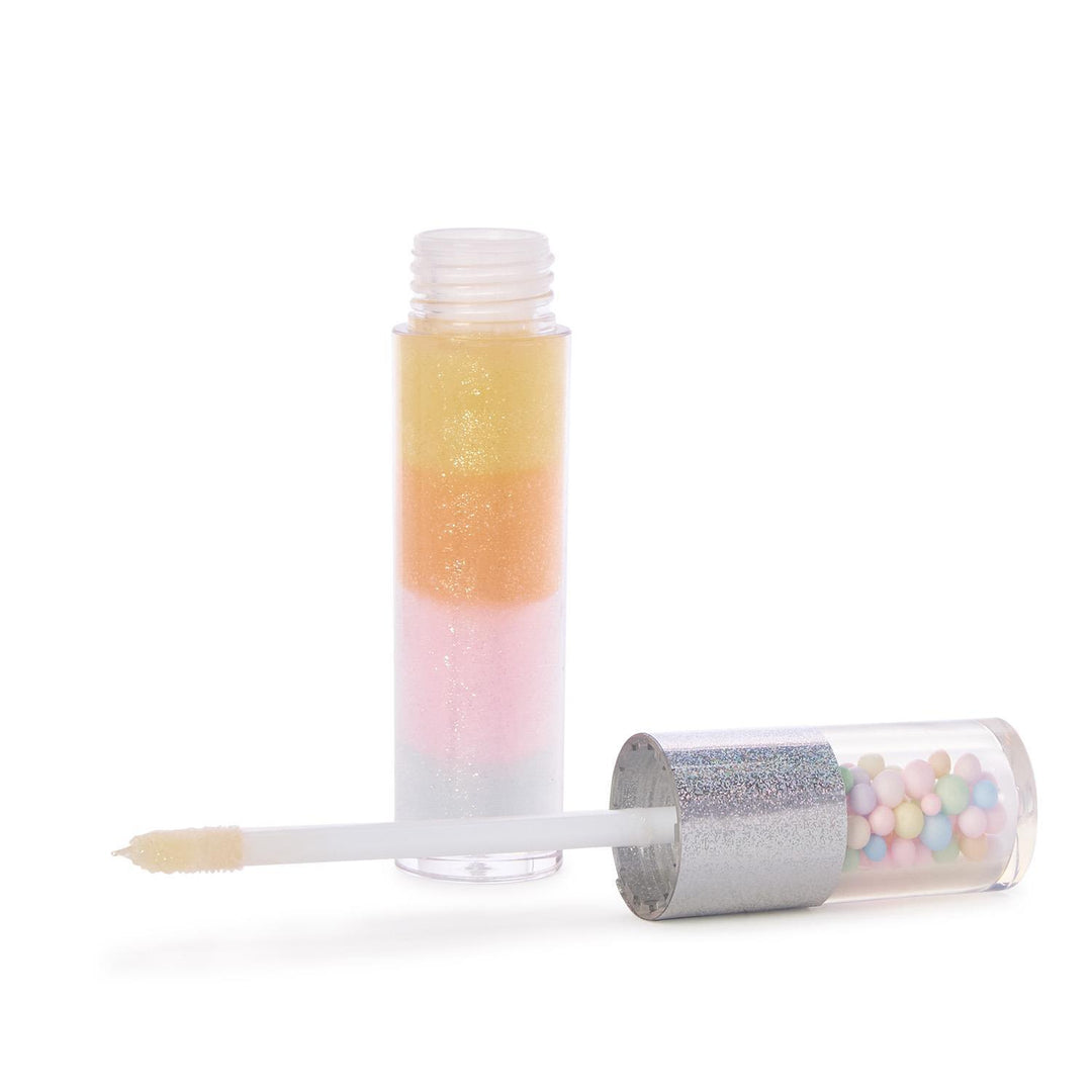 Product photograph of a multi-tiered glitter lip gloss and white applicator wand on a plain white background, featuring horizontal bands of yellow, orange, pink, and white shimmering gloss with a silver glitter cap containing colorful pastel beads