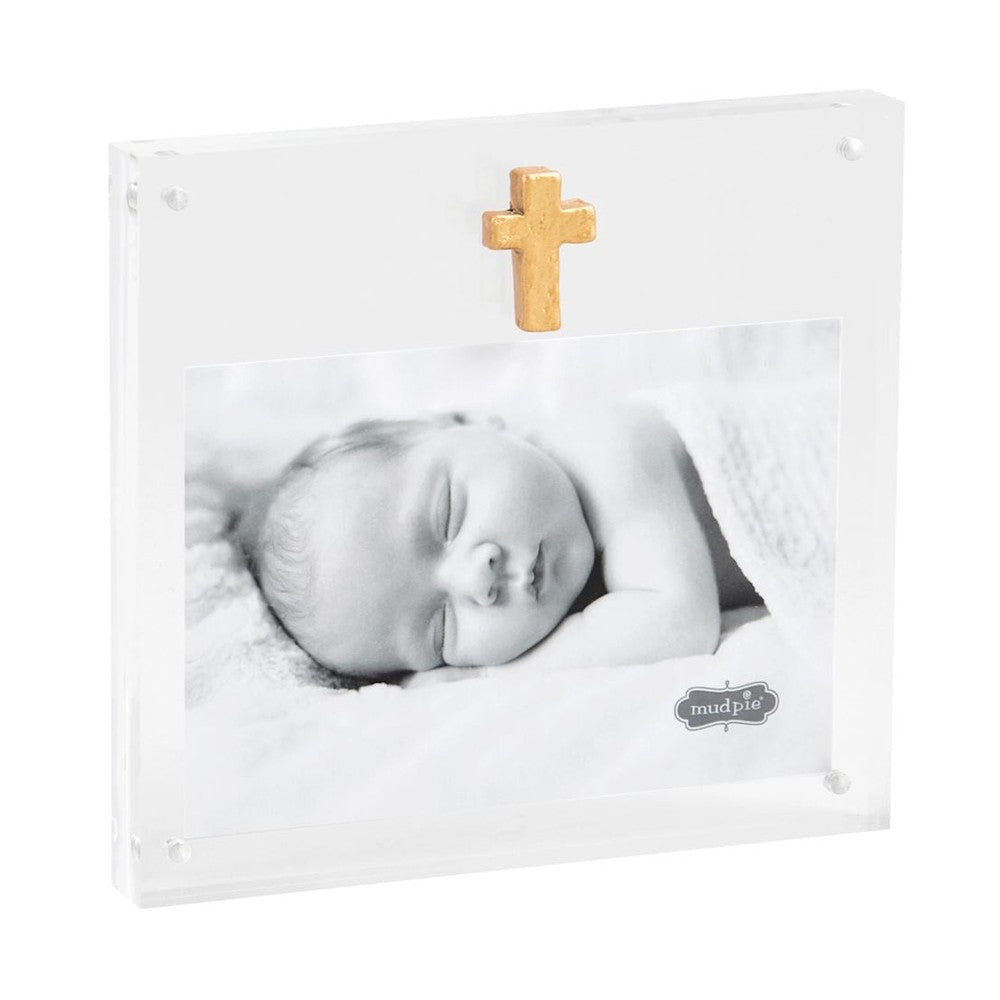 Acrylic photo frame by Mud Pie featuring a black and white photograph of a sleeping baby with a small textured gold cross and magnetic corner fasteners on a white background