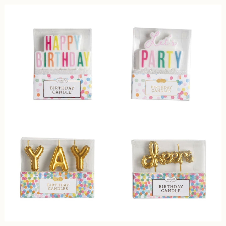 Product photograph by Mud Pie of four birthday candle sets in clear packaging against a white background featuring multi-colored block letters spelling Happy Birthday and Let&