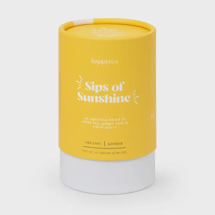 Studio photograph by happytea of a cylindrical yellow tea canister in a neutral studio setting highlighting the Sips of Sunshine brand label with white sunburst graphics and a solid white base