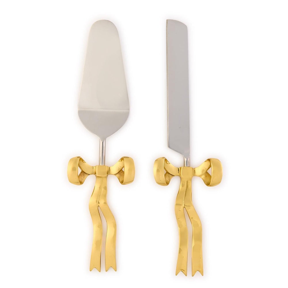 Stainless steel and gold-tone cake server and knife set on a white background featuring decorative hammered bow handles and polished silver-colored blades