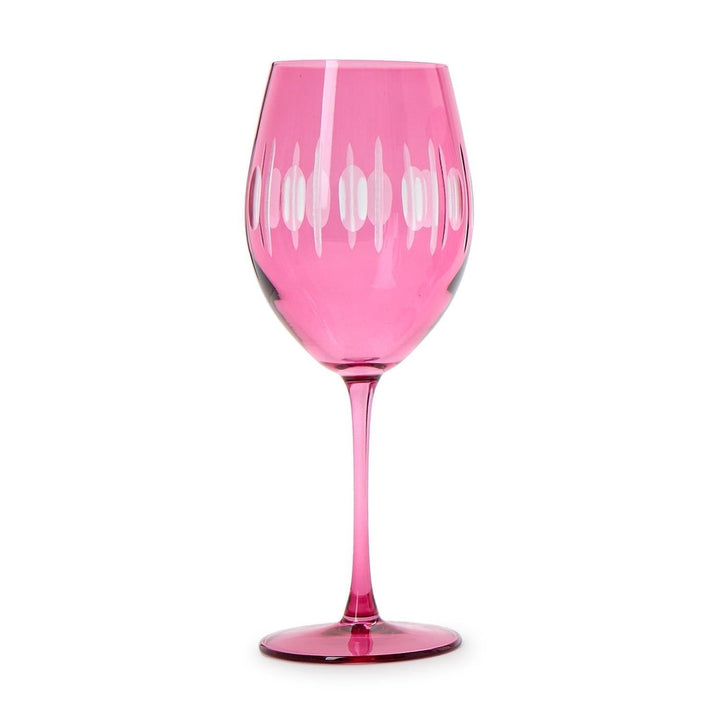 Etched glass wine glass centered on a white background featuring a vibrant fuchsia tint, decorative vertical frosted oval patterns, and a slender tall stem