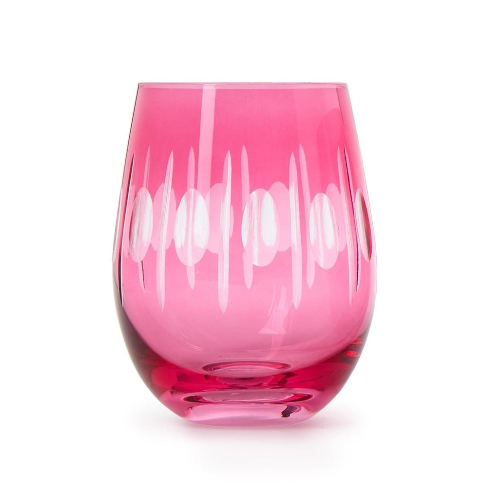 Hand-cut crystal tumbler by Kim Seybert featuring a vibrant fuchsia pink hue with an etched pattern of vertical ovals and a smooth tapered base on a white studio background