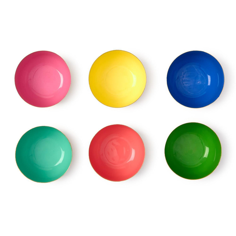 Enamel and metal bowls from the MoMA Design Store featuring a set of six colorful vessels on a white background with glossy interiors in magenta, yellow, and blue finished with thin gold-tone rims