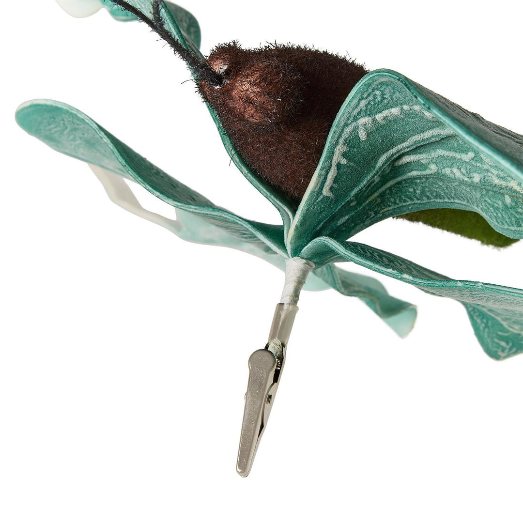 Decorative craft ornament of a clip-on moth featuring a fuzzy brown body and textured teal-green wings with white veining attached to a silver metal clip against a white background