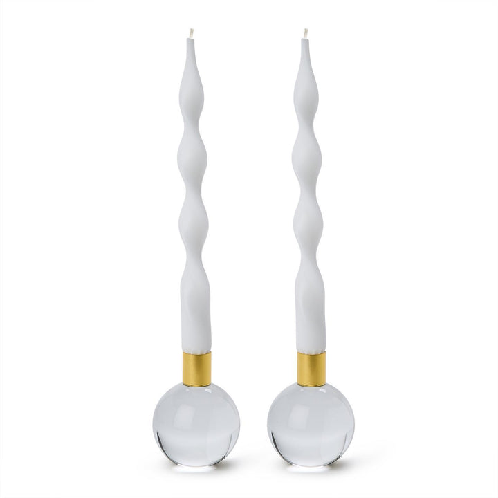 Studio photography of Jonathan Adler crystal orb candle holders on a white background featuring white twisted taper candles, gold-toned brass collars, and solid clear glass spherical bases