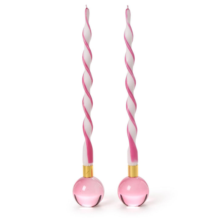 Hand-poured wax and glass art featuring two pink and white spiral-twisted taper candles standing in translucent pink spherical bases with gold-toned metal collars against a white background
