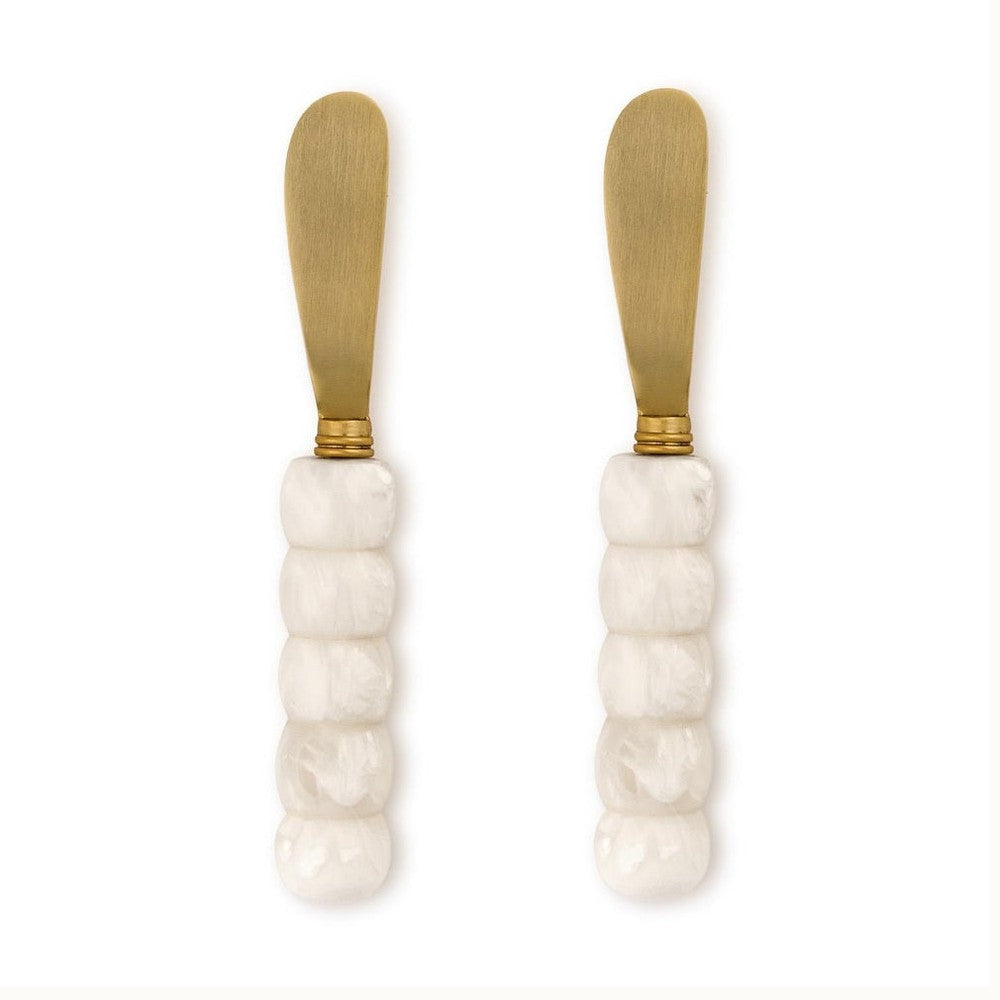 Stainless steel gold-toned spreader knives featuring five-segmented white marbled resin handles and rounded matte blades displayed on a white background