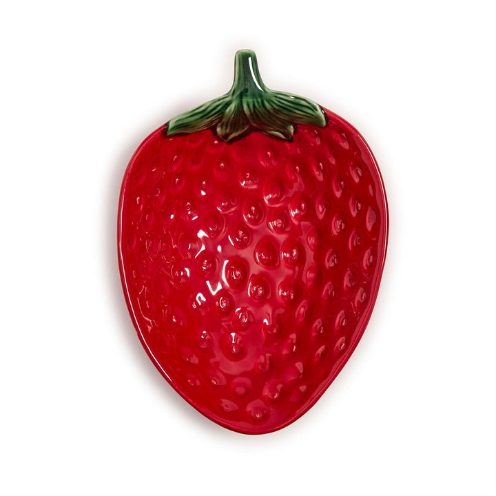 Ceramic strawberry dish by Bordallo Pinheiro centered on a white background showcasing its glossy red glaze, textured seed patterns, and a detailed green leafy stem