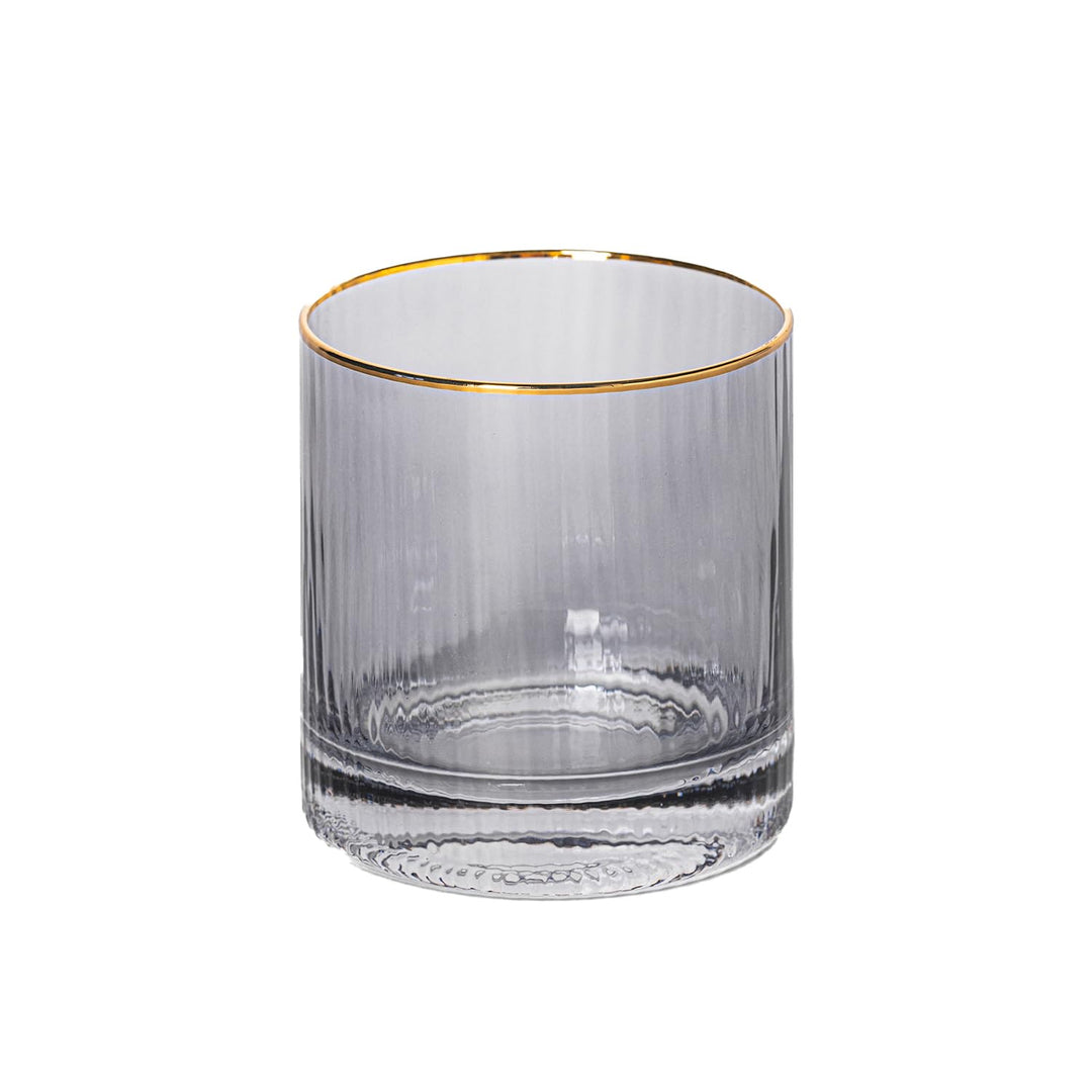 Glassware smoky grey fluted tumbler on a white background featuring a metallic gold rim and vertical ribbed texture