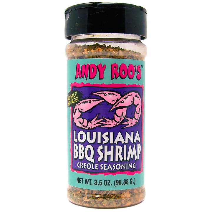 Photograph of Andy Roo’s Louisiana BBQ Shrimp Creole Seasoning bottle on a white background featuring a teal label with two pink shrimp illustrations and a visible blend of dried green and brown herbs through the clear plastic container