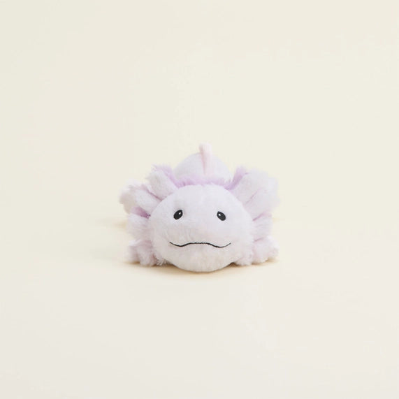 Plush toy by Jellycat of a lavender axolotl centered on a minimalist cream background featuring feathery purple gills, a simple black stitched smile, and soft fuzzy texture