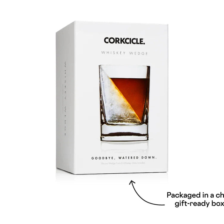 Commercial product photograph by Corkcicle of a white Whiskey Wedge gift box in a studio setting featuring the iconic brand logo, a glass with a sharp diagonal ice formation, and rich amber liquid