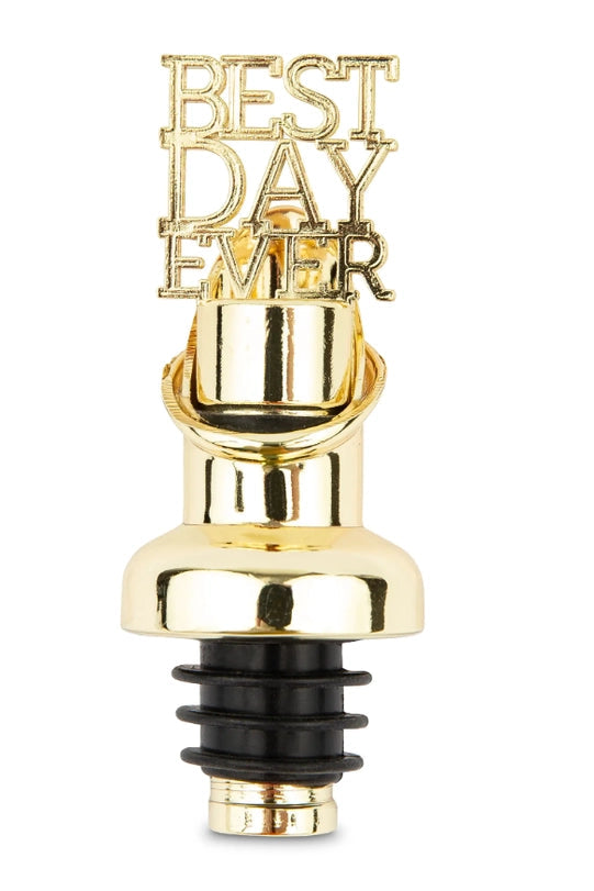 Commercial product photograph of a gold-toned wine bottle pourer on a white background featuring stacked Best Day Ever typography above a polished metallic finish and a black ribbed rubber stopper